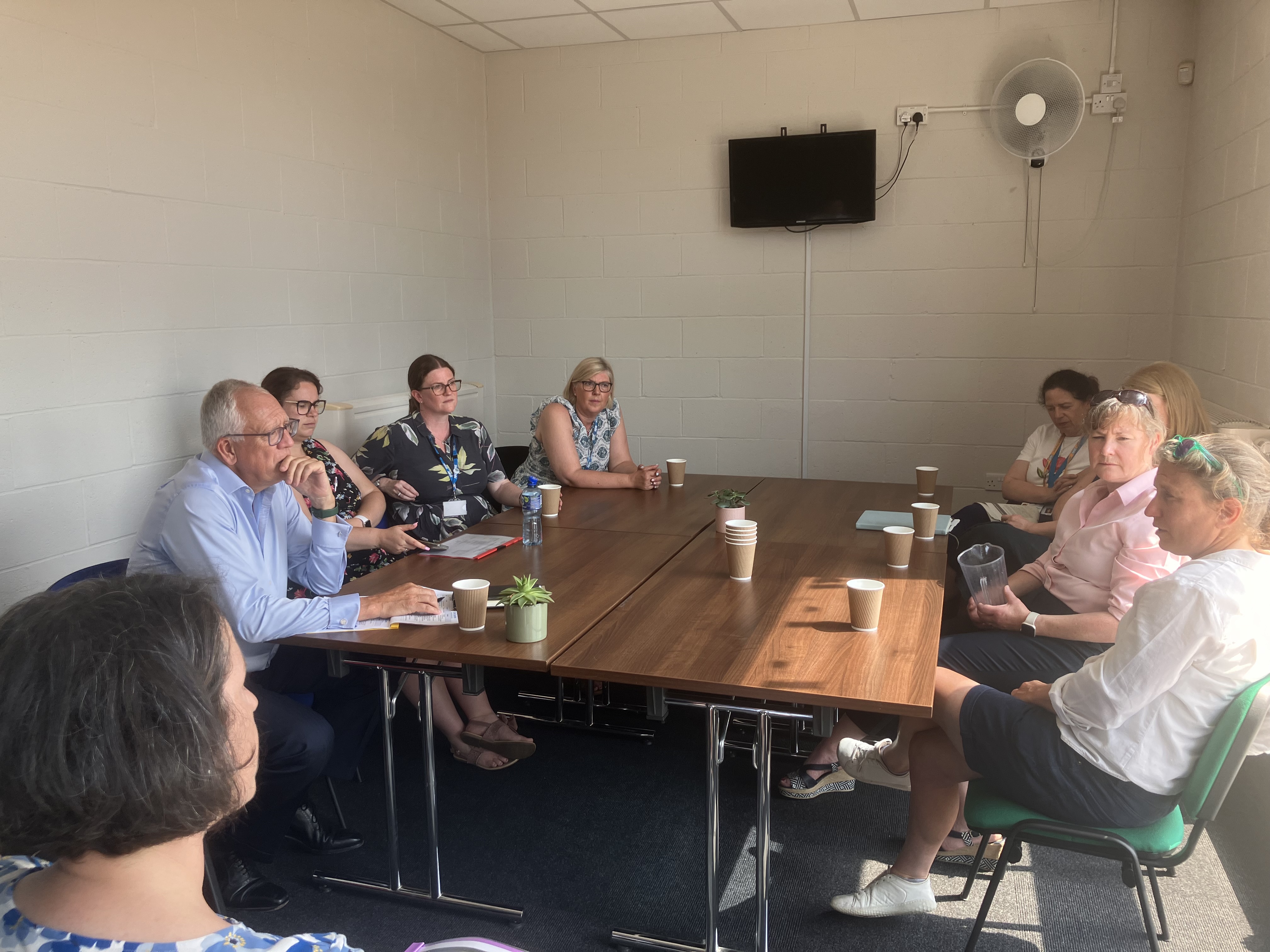 a group sit around a table talking at the Highley Health and Wellbeing Centre
