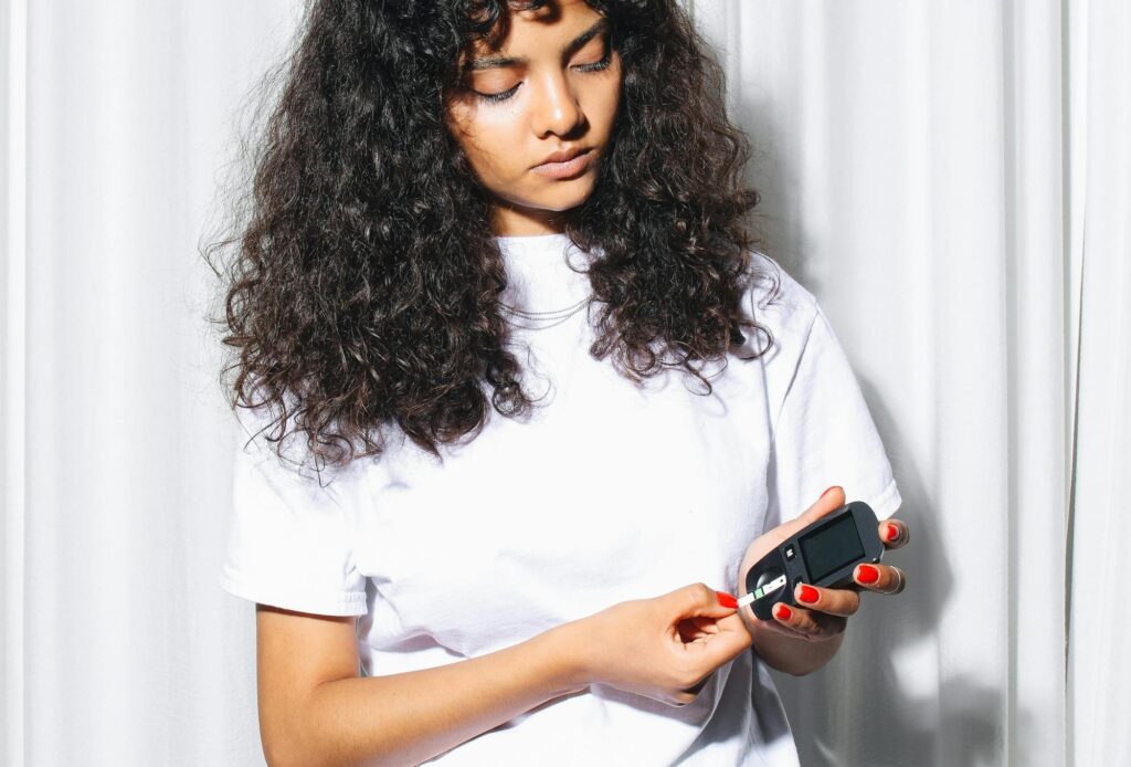 Woman testing blood sugars