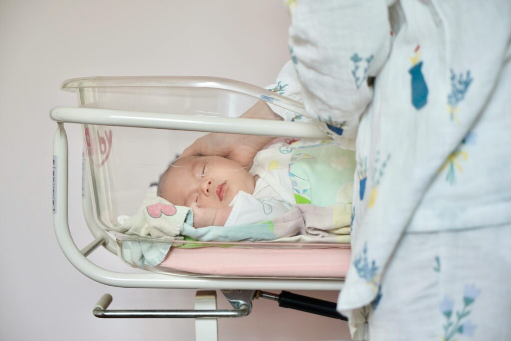 Baby asleep in hospital crib
