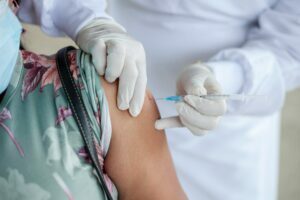 Woman receiving injection from healthcare professional