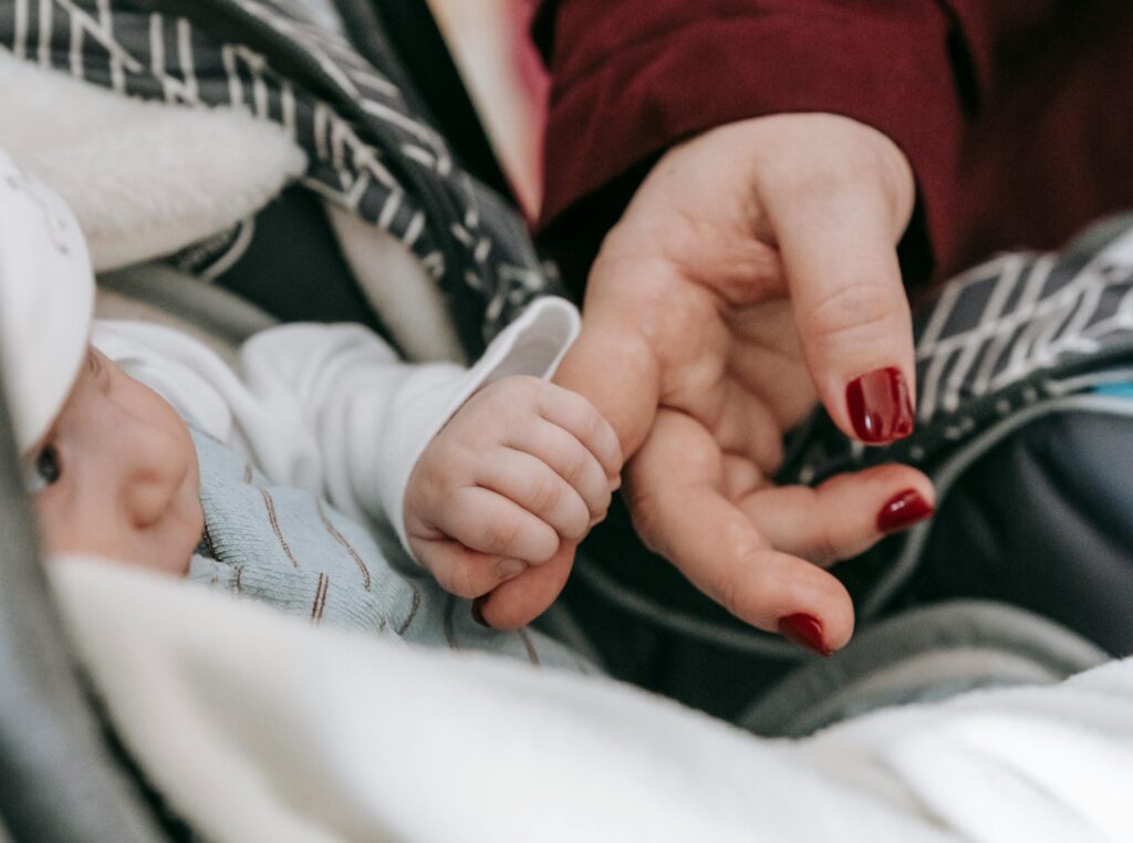 Baby holding adults hand