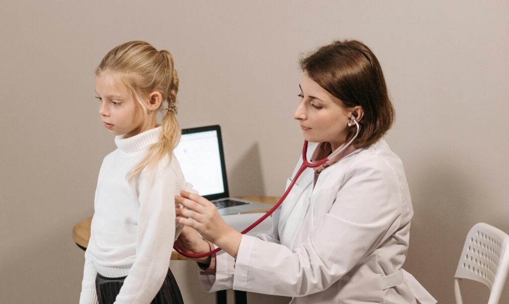 Child having a health check by a doctor